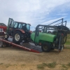 Troy backing tractor and sprayer off the tray
